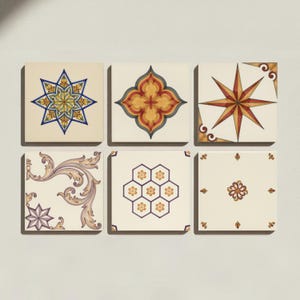 May include: A set of six square ceramic tiles arranged in two rows. Each tile features a unique pattern, including an eight-pointed star, a quatrefoil shape, a compass rose, ornate scrollwork, a honeycomb grid with flowers, and small floral motifs.