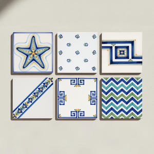 May include: A set of six square ceramic tiles featuring diverse patterns. Designs include a blue starfish, small blue floral motifs, geometric blue lines, a diagonal floral border, a blue Greek key frame, and a blue and green chevron pattern.