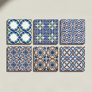 May include: Six square decorative tiles arranged in a grid, each featuring distinct geometric and floral patterns in shades of blue, green, white, and brown. The designs include intricate symmetrical motifs, interlocking lines, and ornate shapes.