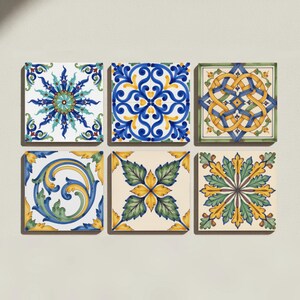 May include: A set of six square ceramic tiles arranged in two rows of three. Each tile features a distinct hand-painted pattern in shades of blue, yellow, green, and cream, showcasing intricate floral, geometric, and swirling scrollwork designs.