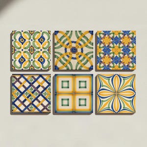 May include: A collection of six square ceramic tiles arranged in two rows of three. Each tile features a distinct geometric or floral pattern in shades of blue, yellow, green, and white, showcasing intricate line work and symmetrical designs.