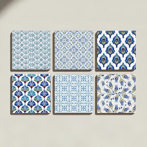 May include: A set of six square ceramic tiles arranged in two rows of three. Each tile features a distinct repeating pattern in shades of blue, green, and white, including floral motifs, geometric shapes, and stylized leaf designs on a white base.