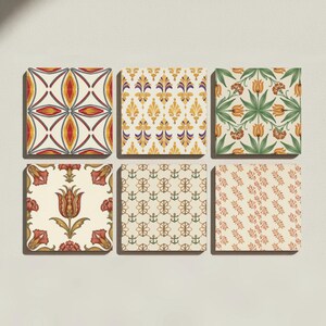 May include: A set of six square tiles arranged in two rows of three. Each tile features a distinct pattern: geometric red and grey shapes, yellow floral motifs, green and orange tulips, a central red tulip, small green anchors, and orange leaf sprigs.