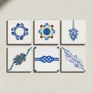 May include: A set of six square white ceramic tiles featuring blue and multicoloured nautical illustrations. Designs include a rope circle, a sea urchin, a cluster of mussels, a mussel on a rope, a blue rope knot, and a fishing net with shells.
