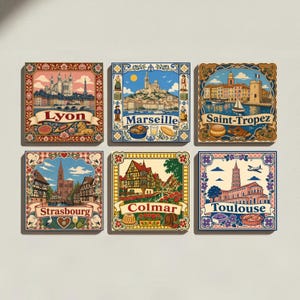 May include: A set of six square decorative tiles featuring colorful illustrations of French cities including Lyon, Marseille, Saint-Tropez, Strasbourg, Colmar, and Toulouse. Each tile displays iconic landmarks, local food, and floral borders with city names.