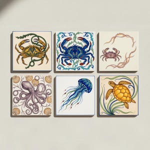 May include: A set of six square ceramic tiles featuring detailed illustrations of marine life, including two crabs, an octopus, a jellyfish, and a sea turtle, all rendered in vibrant colours against cream and white backgrounds with seaweed motifs.