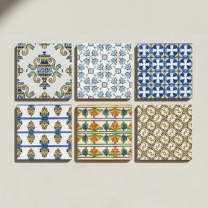 May include: A set of six square ceramic tiles arranged in two rows of three. Each tile features a distinct pattern in blue, yellow, green, and white. Designs include a central urn, floral motifs, geometric circles, and repeating leaf patterns.