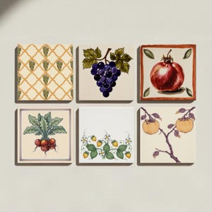May include: A set of six square ceramic tiles featuring various botanical illustrations. Designs include a yellow lattice pattern with grapes, a cluster of purple grapes, a red pomegranate, a bunch of radishes, strawberry plants, and persimmons.