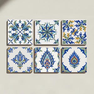 May include: A set of six square ceramic tiles arranged in two rows of three. Each tile features a white background with intricate, symmetrical patterns in shades of blue, green, yellow, and red, displaying floral, star, and leaf-like motifs.