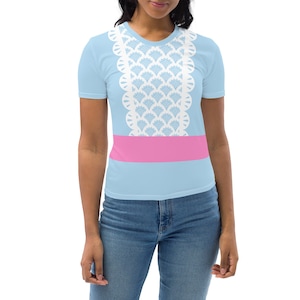 May include: A light blue t-shirt with a white lace trim and a pink band around the waist.
