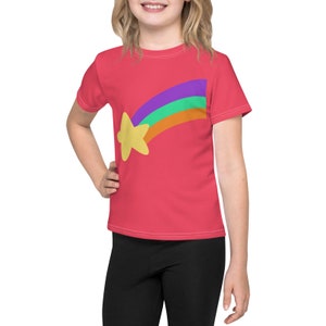 May include: A pink youth-sized t-shirt with a rainbow and yellow star graphic. The rainbow is multi-colored with purple, green, orange, and red stripes.