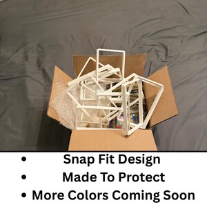 May include: A cardboard box filled with white, geometric, snap-fit designs. The text on the image reads: Snap Fit Design, Made To Protect, More Colors Coming Soon.