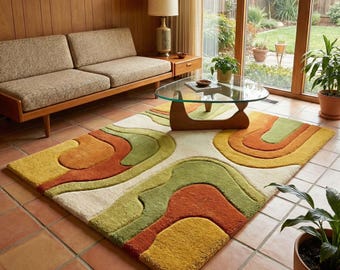 May include: A rectangular area rug with a cream base and a design of abstract shapes in orange, green, and yellow. The rug has a textured surface, adding a retro feel to the room. The rug is suitable for a living room.