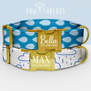 May include: Two personalized dog collars. The top collar is blue with white raindrop patterns and the name "Bella" in gold lettering. The bottom collar is white with blue rain cloud patterns and the name "Max" in gold lettering. Both have gold hardware.