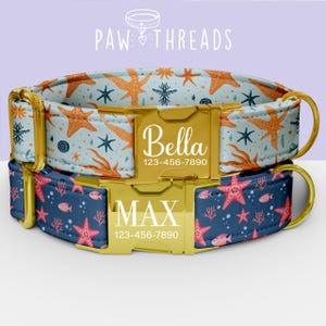 May include: Two personalized dog collars. The top collar has a light blue background with orange starfish and navy blue accents. The bottom collar has a navy blue background with pink starfish and coral. Both have gold buckles.
