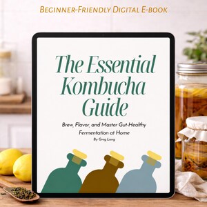 May include: A digital e-book titled "The Essential Kombucha Guide" displayed on a tablet. The cover features text in green and brown, with illustrations of kombucha bottles. The book promises beginner-friendly guidance on brewing, flavoring, and gut-healthy fermentation.