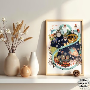 Op de afbeelding: Een ingelijste kunstprint met een kleurrijke illustratie van personages uit een populaire animatiefilm. Het kunstwerk toont verschillende personages, een gele bus en een blauwe rivier. De print wordt tentoongesteld op een witte plank.