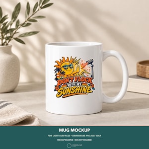 May include: A white ceramic mug featuring a colorful graphic of a smiling sun wearing sunglasses, palm trees, and a camera on a tripod. The text reads DON'T FLOCK WITH MY SUNSHINE in bold orange and blue letters with small hibiscus flower accents.