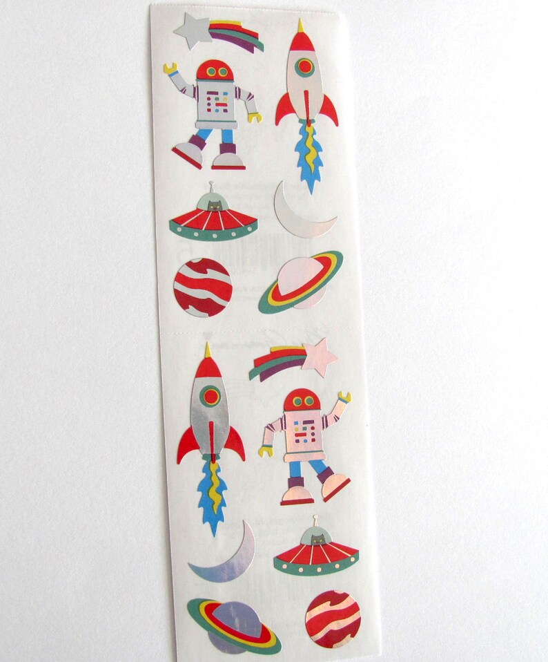 May include: A sheet of colorful space-themed stickers featuring robots, rockets, planets, stars, and UFOs.