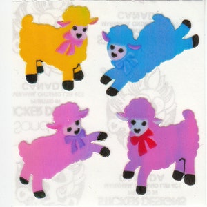 May include: Four colorful lamb stickers with a glossy finish. The lambs are yellow, blue, pink, and purple. Each lamb has a bow tied around its neck.