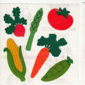 May include: A set of colorful stickers featuring various vegetables, including a red tomato, a green asparagus, a yellow corn cob, a green pea pod, a red radish with green leaves, and an orange carrot with green leaves.