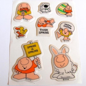May include: A sheet of vintage stickers featuring cartoon characters in various poses. The stickers include images of a dog, duck, Easter egg, and a figure holding a sign that reads "Spring is Sprung." Other stickers say "Happy Easter" and "Think Spring."