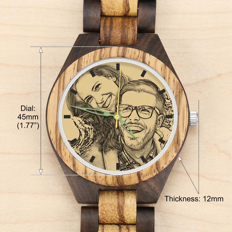 May include: A wooden wristwatch featuring a light-colored dial with a custom engraved portrait of a smiling couple. The watch has a dark and light wood grain band, a 45mm (1.77 inch) diameter dial, and a case thickness of 12mm as indicated by text.