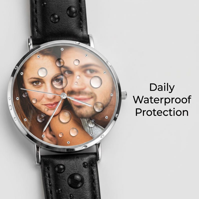 Peut inclure: Une montre-bracelet avec un bracelet en cuir noir et un bo&icirc;tier en m&eacute;tal argent&eacute;. Le cadran pr&eacute;sente une photographie personnalis&eacute;e d'un couple, recouverte de gouttelettes d'eau r&eacute;alistes. Le texte Daily Waterproof Protection est inscrit &agrave; droite.