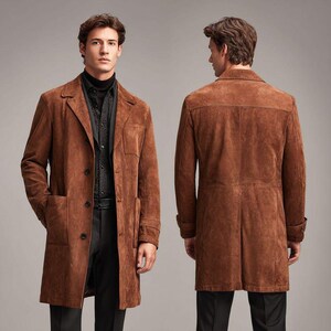 May include: A brown suede coat with a classic design. The coat features a notched lapel, two front pockets, and a button closure. The coat is shown from the front and back, showcasing its tailored fit and details.