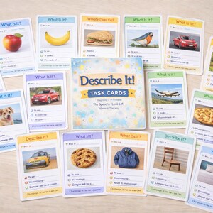 May include: A collection of "Describe It!" task cards, featuring images of various objects like a red apple, a car, a dog, and a pizza. The cards are arranged around a central box with the game's title.