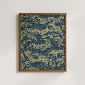 May include: A framed print featuring a detailed floral pattern in shades of navy blue and cream. The artwork showcases a dense arrangement of stylized flowers and foliage, creating a textured, almost tapestry-like appearance. The frame is a warm gold color.
