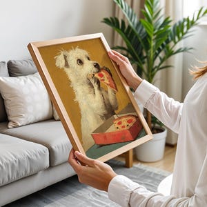 May include: A framed print depicting a white dog enjoying a slice of pizza from a red box. The artwork has a vintage aesthetic, set against a yellow backdrop, within a wooden frame. The dog is the main subject of the image.