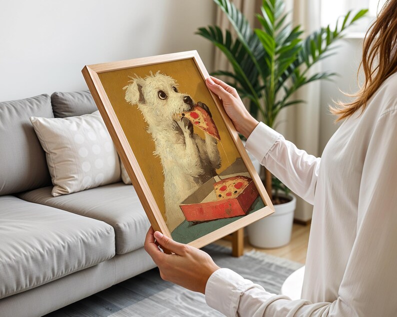May include: A framed print depicting a white dog enjoying a slice of pizza from a red box. The artwork has a vintage aesthetic, set against a yellow backdrop, within a wooden frame. The dog is the main subject of the image.