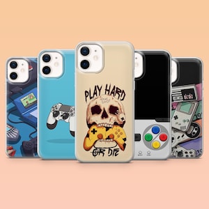 May include: A collection of phone cases with gaming-themed designs. One case features a skull holding a yellow game controller with the text "PLAY HARD OR DIE." Other cases display game controllers and retro gaming consoles in various colors.