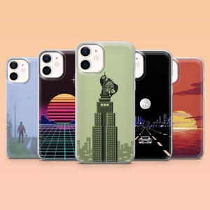 May include: A set of five phone cases with pixel art designs in a retro style. The cases display images of cityscapes, sunsets, and the Statue of Liberty. The cases are in various colours, including blue, black, and red.