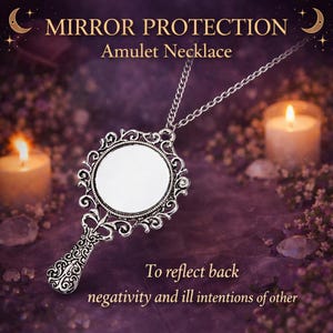 May include: A silver-toned metal pendant necklace featuring a small, round mirror set within an ornate, filigree-style frame with a handle. The text MIRROR PROTECTION Amulet Necklace and To reflect back negativity and ill intentions of other is visible.