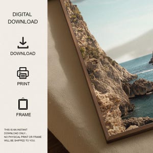 May include: A framed print featuring a coastal landscape with rocky cliffs and turquoise water. The print is in a dark wood frame. Text on the left side indicates this is a digital download, with options to download, print, and frame.