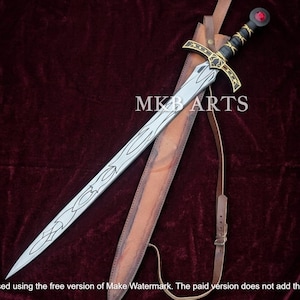May include: A silver-colored sword with intricate black line engravings on the blade, a black handle with gold accents, and a red circular pommel stone. The sword is accompanied by a brown leather scabbard with a strap. The text MKB ARTS is visible.