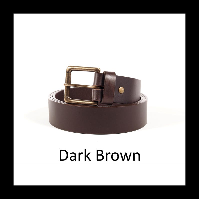 May include: A dark brown leather belt with a rectangular brass buckle. The belt is rolled up, displaying its color and texture. The text "Dark Brown" is displayed below the belt.