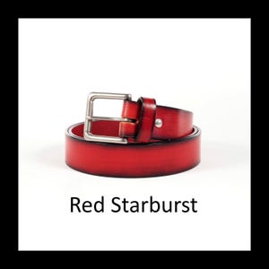 May include: A rolled-up red leather belt with a silver-colored buckle. The belt is a vibrant red color and features a single silver stud. The text "Red Starburst" is displayed below the belt.