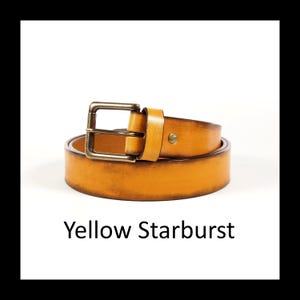 May include: A yellow leather belt with a brass buckle is coiled on a white background. The belt is a vibrant yellow color with a slightly distressed finish. The text "Yellow Starburst" is below the belt.