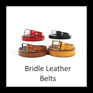 May include: Four leather belts in red, black, brown, and yellow, each with a silver or brass buckle. The belts are arranged in pairs, with the text "Bridle Leather Belts" below.