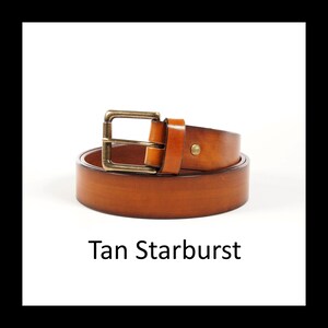 May include: A tan leather belt with a brass buckle is coiled on a white background. The belt is a light brown color and has a simple, classic design. The text "Tan Starburst" is displayed below the belt.