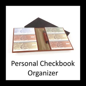 May include: A brown leather-like personal checkbook organizer featuring a central pen loop and multiple clear plastic sleeves containing various colored checks with floral patterns. The text Personal Checkbook Organizer is displayed below the open item.
