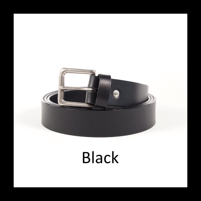 May include: A black leather belt with a silver-colored buckle. The belt is rolled up, displaying its full length. The word "Black" is printed at the bottom of the image. This belt is a classic accessory.