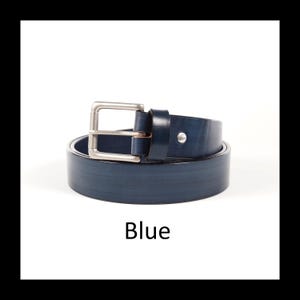 May include: A rolled-up blue leather belt with a silver-colored buckle. The word "Blue" is written in a bold font at the bottom of the image. The belt is a classic accessory.