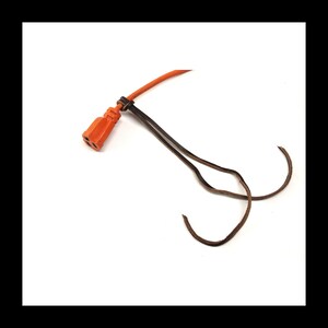 May include: An orange electrical cord with a three-pin plug and brown wires. The cord is secured with a black cable tie against a white background. The cord is used for electrical devices.