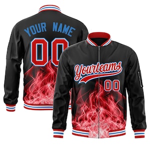 May include: Black bomber jacket with red and white accents. The jacket features a red flame design, the text "Yourteams" in red script, and the number "00" in red. The back of the jacket has the text "YOUR NAME" and the number "00".