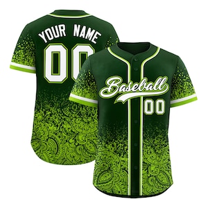 May include: A dark green baseball jersey with white and lime green accents. The jersey features the word "Baseball" in white script, the number "00", and a paisley design. The back of the jersey has the words "YOUR NAME" and the number "00".