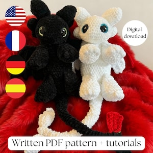May include: Two crocheted dragon plushies, one black and one white, with large eyes and small wings. The black dragon has green eyes, and the white dragon has blue eyes. The image includes the text "Digital download" and "Written PDF pattern + tutorials".